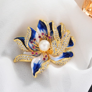 Elegant gold lotus brooch with blue enamel petals, white pearl center and zircon accents