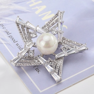 Elegant star brooch featuring a large center pearl and sparkling cubic zirconia crystals