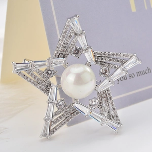 Star-shaped zircon brooch with a large white pearl center and silver setting