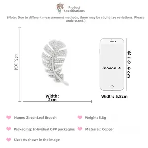 Detailed view of silver zircon leaf brooch showing 5.1cm length against a phone reference