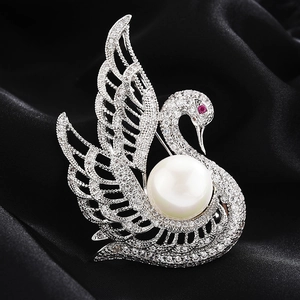 Elegant silver swan brooch with sparkling cubic zirconia and large white pearl detail