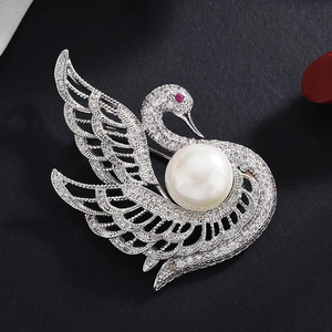 Elegant silver swan brooch with sparkling zircons and a large white pearl center