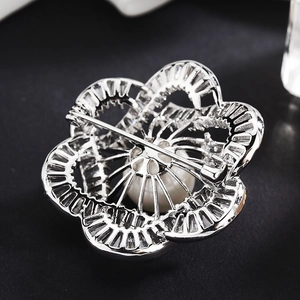 Silver flower brooch with pearls and rhinestones showing the secure back pin clasp