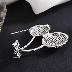 Fashionable cherry brooch with zircon details and silver textured honeycomb back
