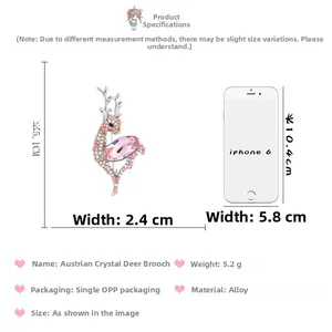 Macro view of crystal deer brooch with pink stones compared to an iPhone for size scale