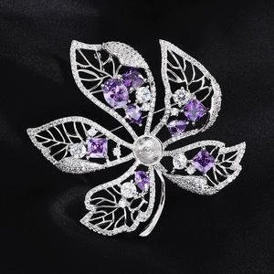 Detail of flower brooch base with purple gemstones and white zircon on black silk