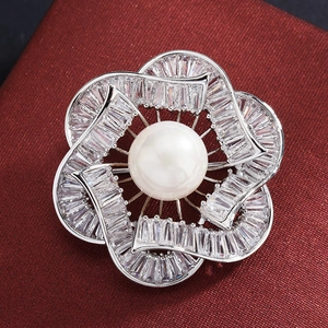 Flower bud brooch with white pearl and cubic zirconia in polished silver finish