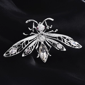 Macro view of cicada insect brooch with sparkling zircon wings and red crystal eyes