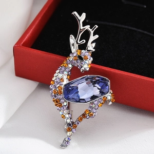 Close-up of elegant silver deer brooch with colorful rhinestones and blue-purple crystal