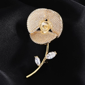 Macro detail of gold flower brooch base with zircon paving on elegant black satin