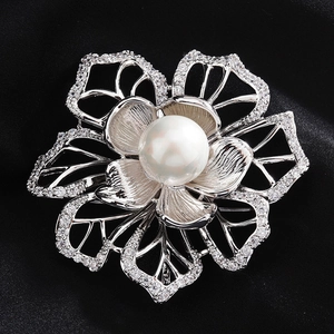 Close-up of floral brooch with micro-pave zircons and a large white round pearl