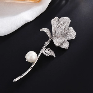 Elegant silver rose brooch with micro-pave zircons and white pearl on black background