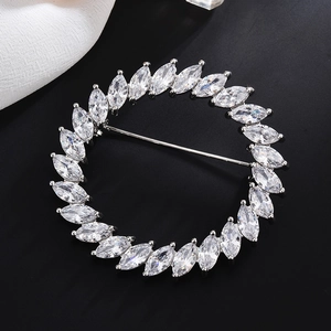 Elegant circular zircon brooch with marquise-cut stones on a silver metal base