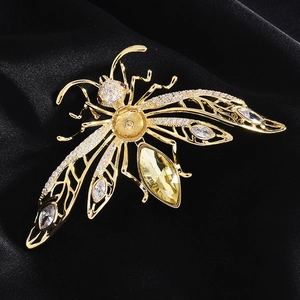 Macro detail of bee brooch setting with zircons and yellow gemstone for DIY pearl