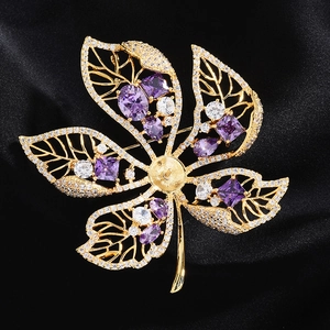 Detailed leaf-shaped brooch in gold alloy featuring zircon accents and colorful gems