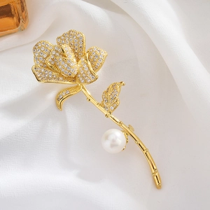 Elegant rose brooch with white pearls and sparkling zircons on gold plated petals