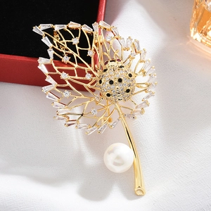 Detail of leaf brooch with zircons, ladybug accent, and a large round pearl drop