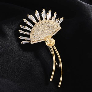 Macro shot of gold-plated zircon brooch base with fan-shaped design on black silk