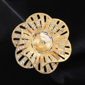 Macro detail of a golden flower brooch base with hollow zircon-studded petals