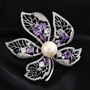 Detail of five-petal flower brooch with large white pearl and purple gemstones