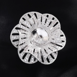 Elegant silver camellia flower brooch setting with cubic zirconia on black silk