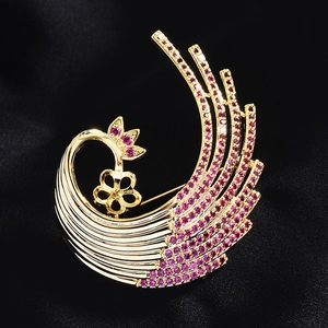 Golden peacock feather brooch with purple zircon stones on black satin background