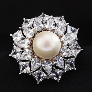 Elegant silver flower brooch with a large white pearl and sparkling zircon crystals