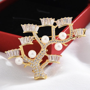 Elegant gold tree-shaped brooch with white pearls and sparkling cubic zirconia stones