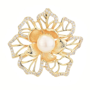 Elegant gold flower brooch with white pearl and sparkling zircon accents on white background