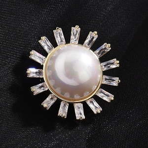 Elegant sunflower magnetic shell brooch with pearl and rectangular zircons on black fabric