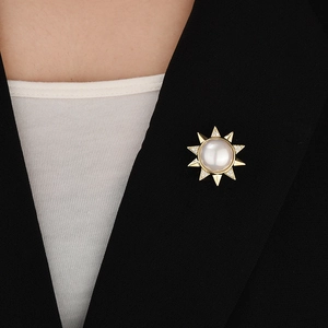 Detailed view of sunflower magnet brooch with pearl and crystals on a black suit blazer