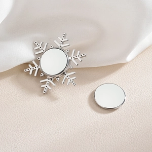 Elegant silver snowflake pearl brooch with magnetic clasp on a white silk background