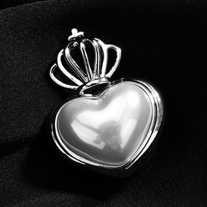 Elegant silver heart crown brooch pin with high-gloss metallic finish on black silk