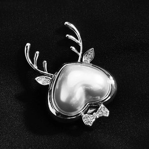 Elegant heart pearl reindeer brooch with zircon antlers on black velvet background