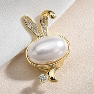 Elegant gold rabbit brooch featuring a large pearl and sparkling zircon stone accents