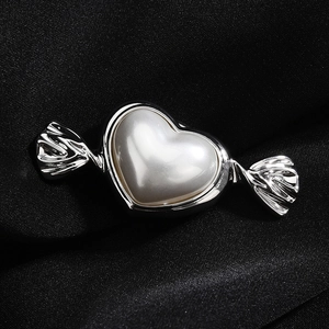 Elegant heart pearl magnetic candy brooch pin for shirt collar over black silk background
