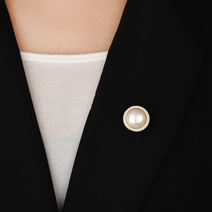Elegant magnetic pearl brooch with zircon accents on a black suit lapel for women