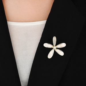 Elegant zircon flower brooch with pearl luster petals on a black suit lapel