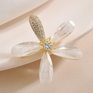 Exquisite golden flower brooch with shimmering petals and sparkling zircon center stone