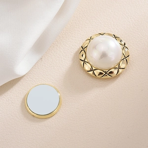 Elegant magnetic brooch featuring large white pearl with quilted gold metal border