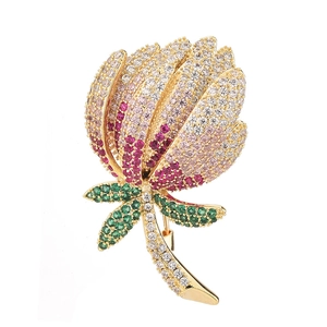 Elegant flower brooch with sparkling zircon petals and green leaves on gold base