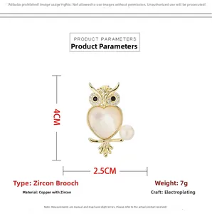 Detailed view of owl brooch with heart-shaped mother of pearl and zircon stones