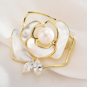 Elegant shell flower brooch with white pearl and sparkling crystals in gold finish