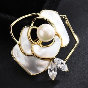 Elegant gold camellia brooch with white shell petals, center pearl and zircon accents
