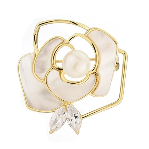 Elegant gold camellia brooch with white shell petals and a centered pearl accent