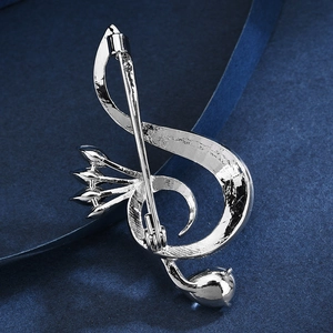 Silver musical note brooch featuring a polished finish and a secure metal pin closure back