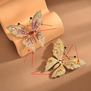 Detail of elegant butterfly brooches featuring colorful zircon stones and gold plating