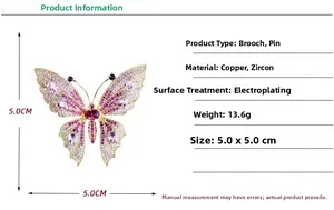 Detail view of gold-plated butterfly brooch with pink and white cubic zirconia stones