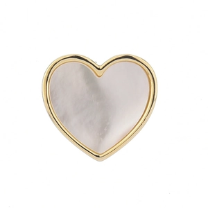 Close-up of heart-shaped brooch featuring gold metal edges and white mother of pearl inlay