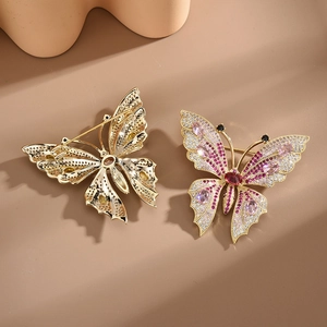 Elegant gold butterfly brooch with pink and purple zircons shown from front and back view